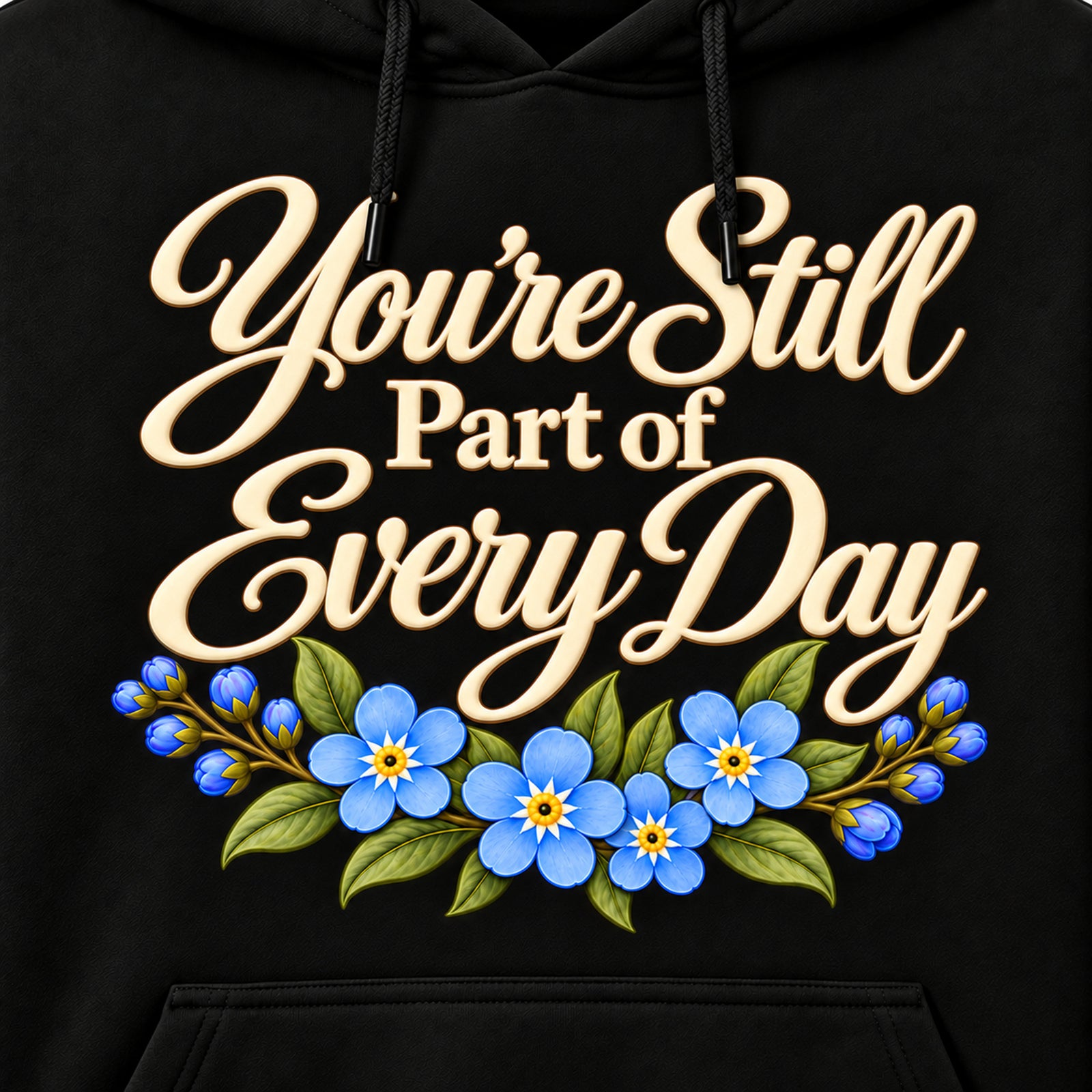 Closeup of You're Still Part of Every Day ivory lettering and blue flowers with black drawstrings in front