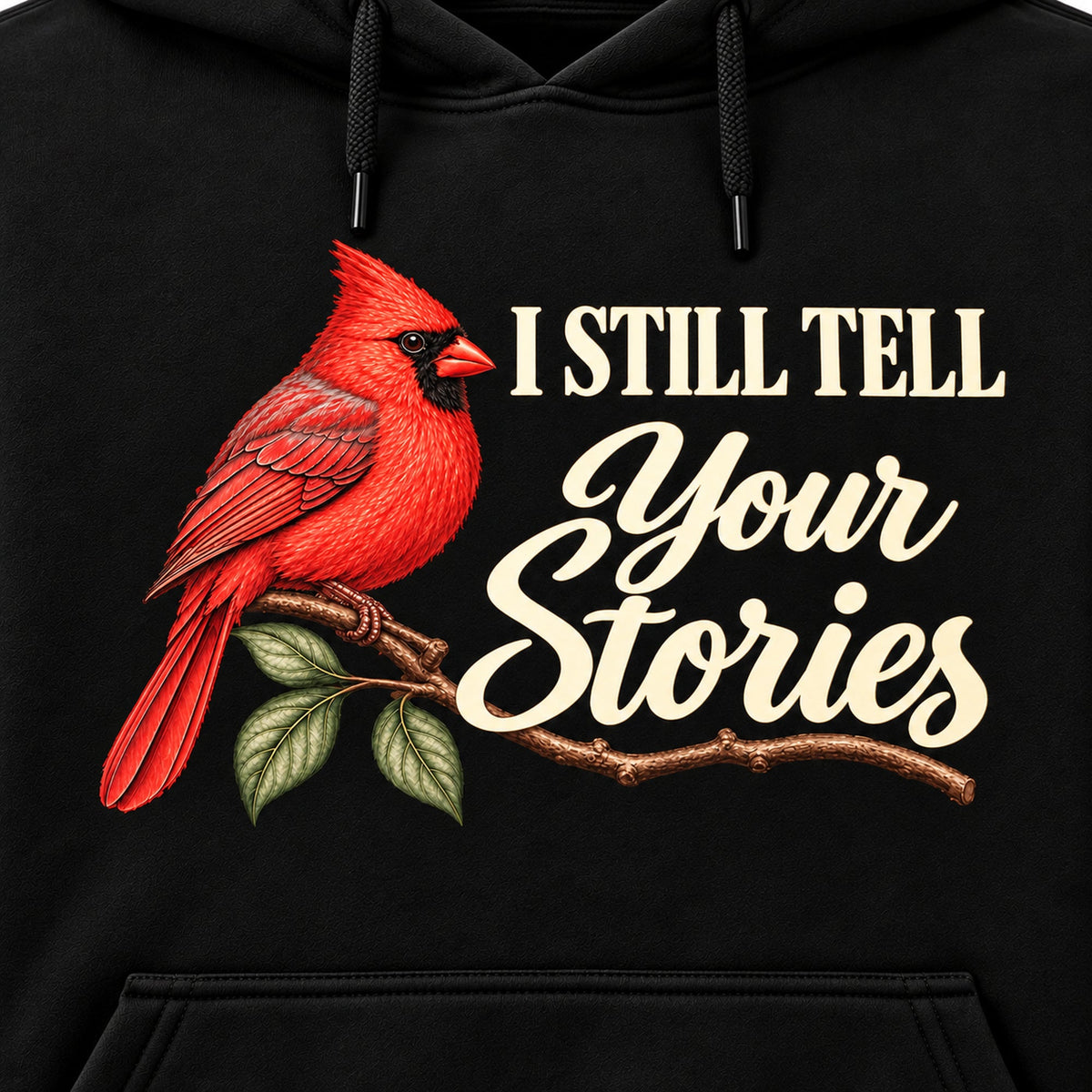 Closeup of revised I Still Tell Your Stories cardinal and ivory lettering on black hoodie