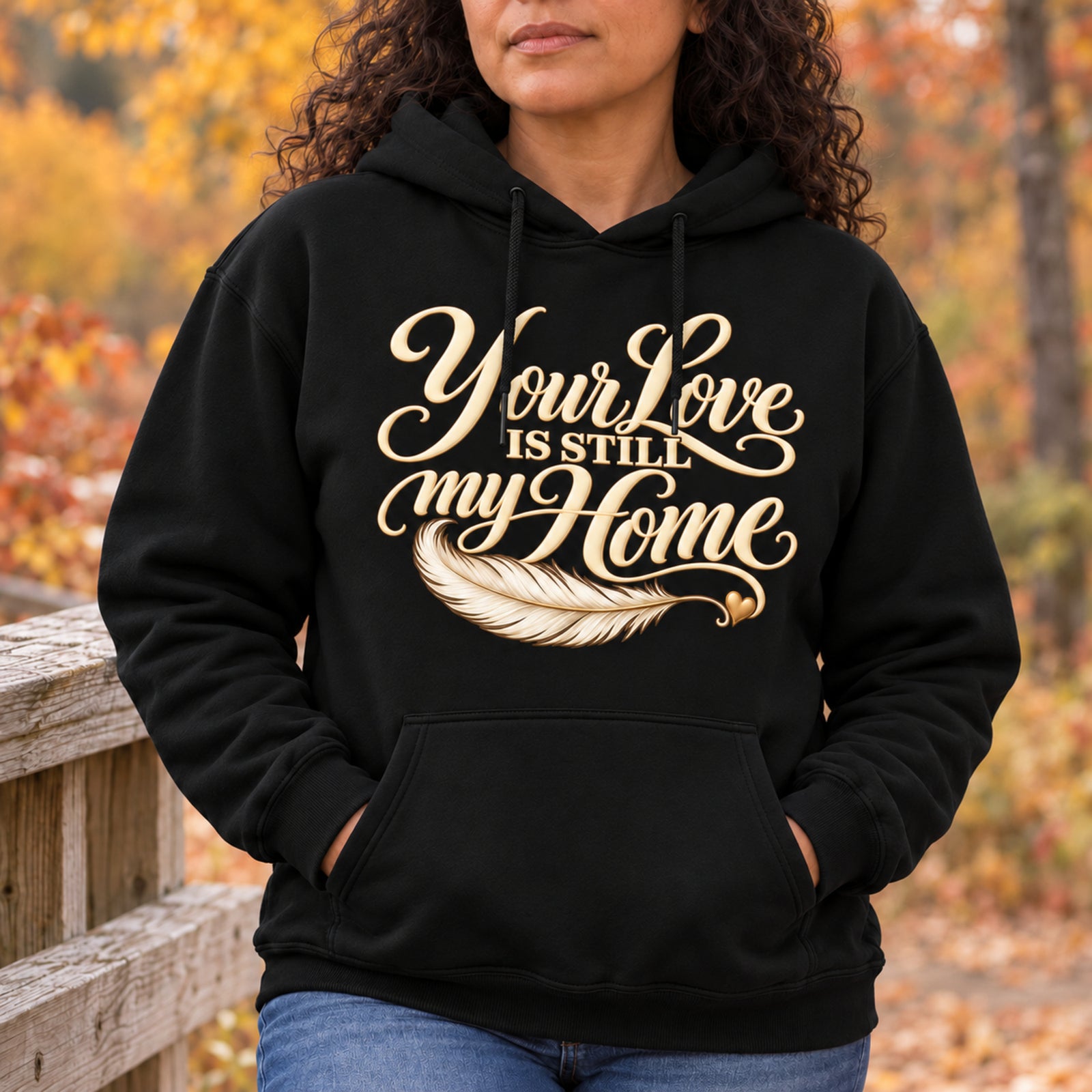 Woman wearing the black Your Love Is Still My Home memorial hoodie