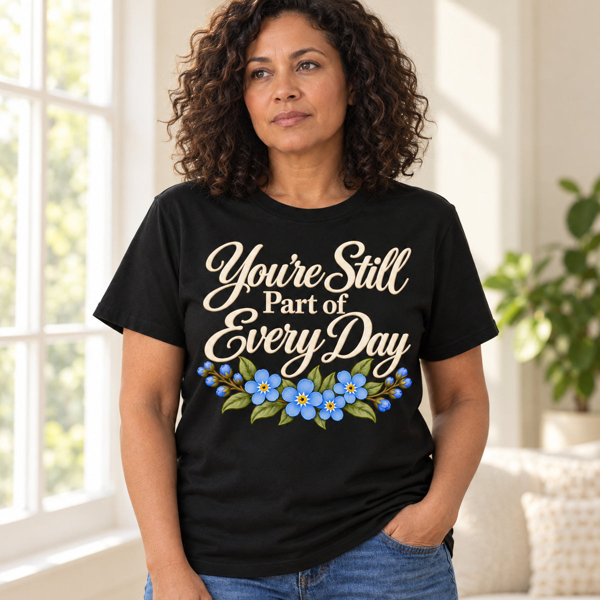 Reflective woman wearing the black You're Still Part of Every Day memorial T-shirt